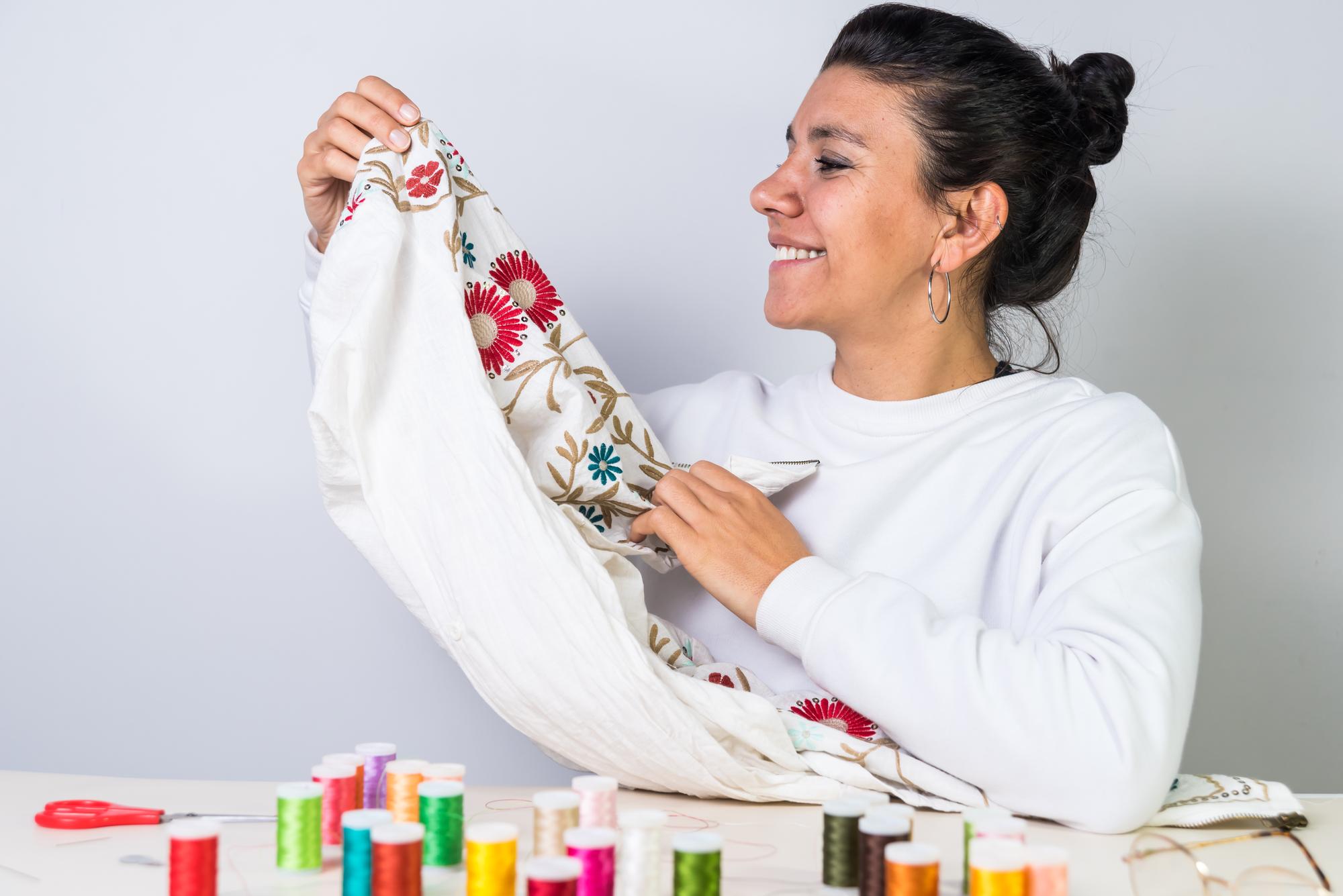 Artist stitching embroidery in a bright workshop